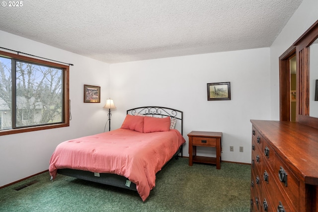 carpeted bedroom featuring a textured ceiling, visible vents, and baseboards