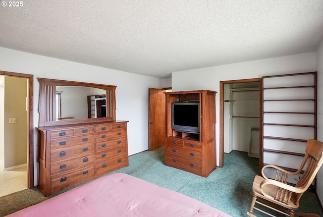 bedroom with carpet floors, a textured ceiling, and radiator heating unit