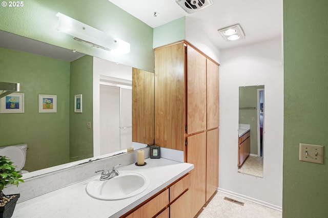 bathroom with visible vents, vanity, and toilet