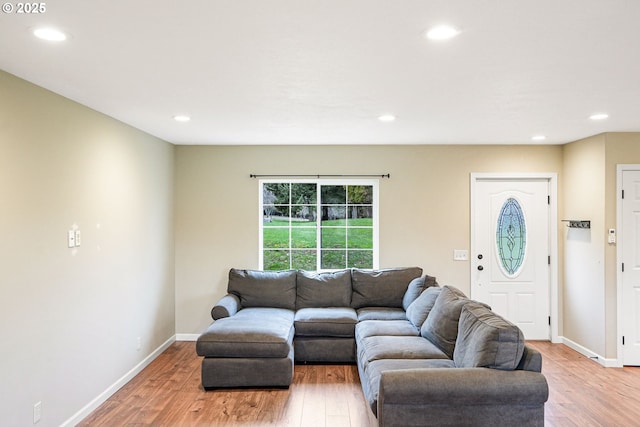 living room with baseboards, recessed lighting, and light wood-style floors