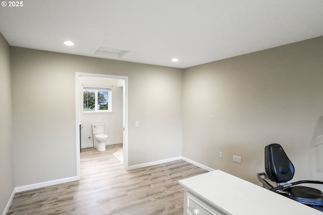 unfurnished office featuring light wood-type flooring, attic access, baseboards, and recessed lighting