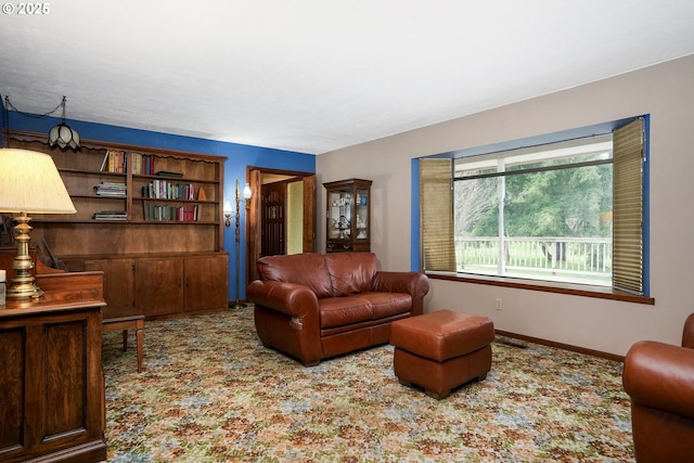 carpeted living area featuring baseboards