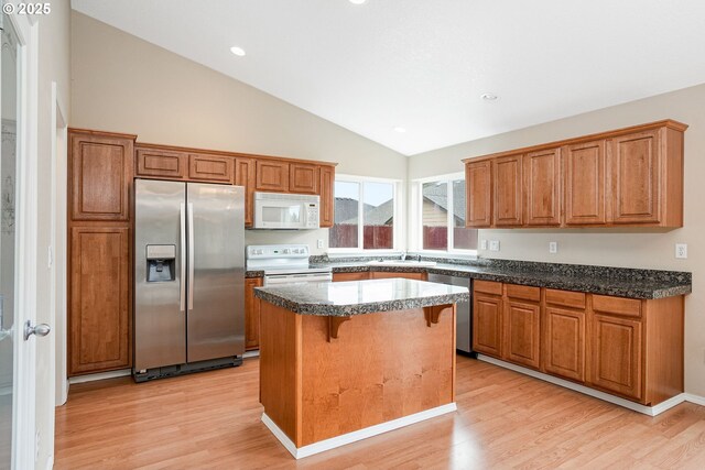 967 Whippoorwill Ct NW, Salem, OR 97304 - kitchen featuring appliances with stainless steel finishes, vaulted ceiling, light wood finished floors, a center island, and recessed lighting