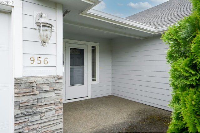 967 Whippoorwill Ct NW, Salem, OR 97304 - doorway to property featuring roof with shingles and stone siding