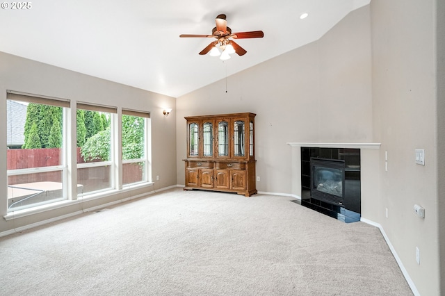 967 Whippoorwill Ct NW, Salem, OR 97304 - unfurnished living room with light carpet, ceiling fan, a tiled fireplace, and high vaulted ceiling