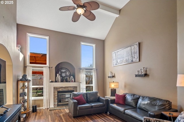 living room with hardwood / wood-style floors, a fireplace, high vaulted ceiling, and ceiling fan