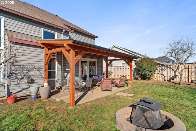 back of house featuring a patio and a yard