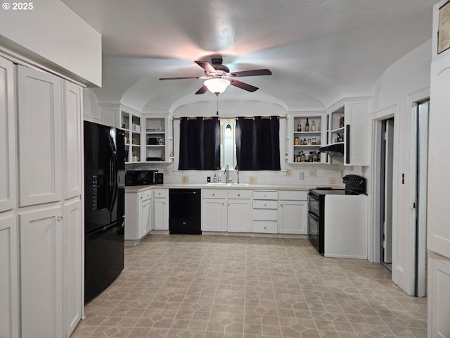 kitchen with vaulted ceiling, sink, white cabinets, ceiling fan, and black appliances