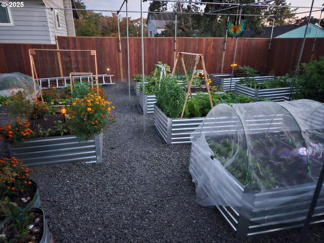 view of yard featuring a vegetable garden and fence