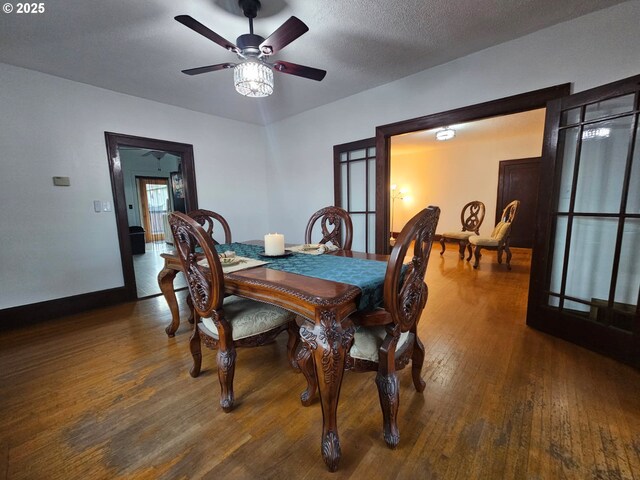 dining space with ceiling fan, a textured ceiling, baseboards, and hardwood / wood-style floors