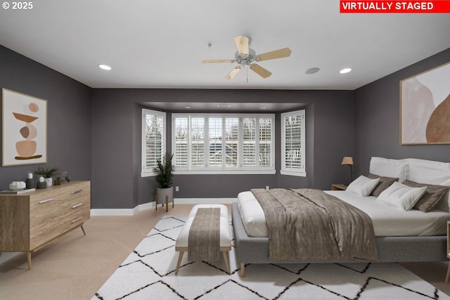 bedroom with ceiling fan and light carpet