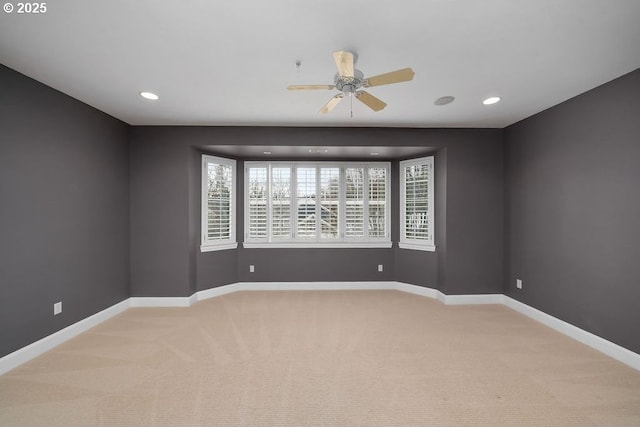 carpeted empty room featuring ceiling fan