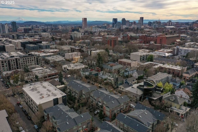 aerial view at dusk featuring a mountain view