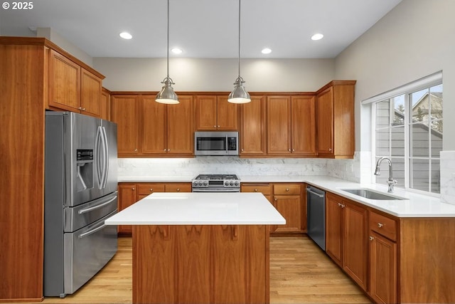 kitchen with sink, hanging light fixtures, tasteful backsplash, a kitchen island, and stainless steel appliances