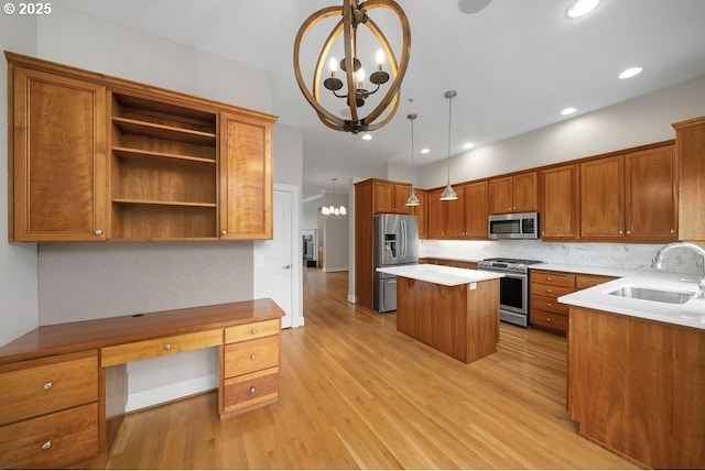 kitchen featuring pendant lighting, a center island, sink, appliances with stainless steel finishes, and a notable chandelier