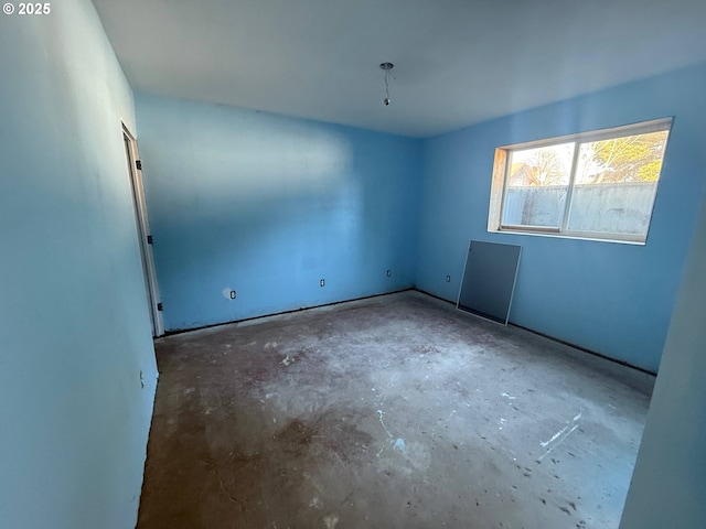 spare room featuring concrete flooring