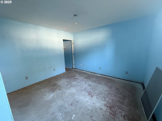 spare room featuring unfinished concrete flooring