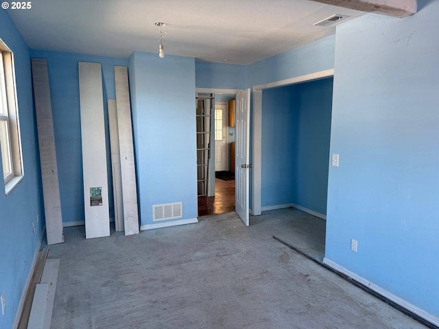 unfurnished bedroom with baseboards and visible vents