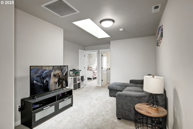 carpeted living area with a skylight