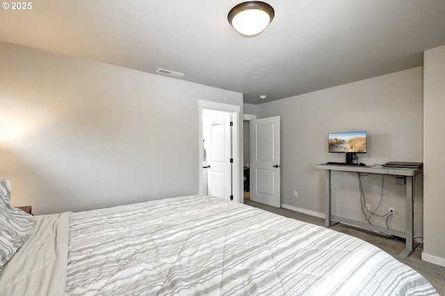 bedroom with baseboards and carpet