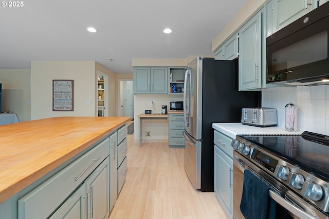 13465 SW Lancewood St, Beaverton, OR 97008 - kitchen featuring stainless steel appliances, wooden counters, decorative backsplash, light wood-style flooring, and recessed lighting