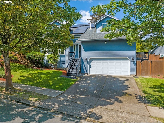 13465 SW Lancewood St, Beaverton, OR 97008 - view of front of property featuring driveway, an attached garage, a gate, roof with shingles, and solar panels