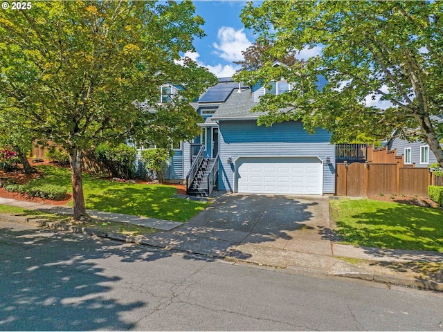 13465 SW Lancewood St, Beaverton, OR 97008 - obstructed view of property with concrete driveway, an attached garage, and solar panels