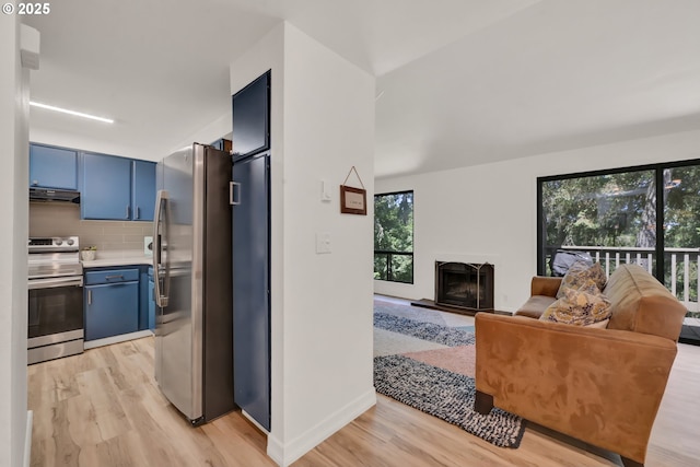103 Treehill Loop, Eugene, OR 97405 - kitchen with appliances with stainless steel finishes, blue cabinets, light wood finished floors, and backsplash
