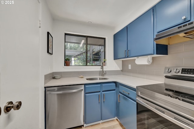 103 Treehill Loop, Eugene, OR 97405 - kitchen featuring stainless steel appliances, blue cabinets, under cabinet range hood, and backsplash