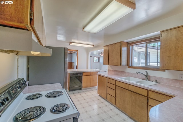 30563 Fairview Rd, Lebanon, OR 97355 - kitchen with white range with electric stovetop, a sink, under cabinet range hood, light floors, and light countertops