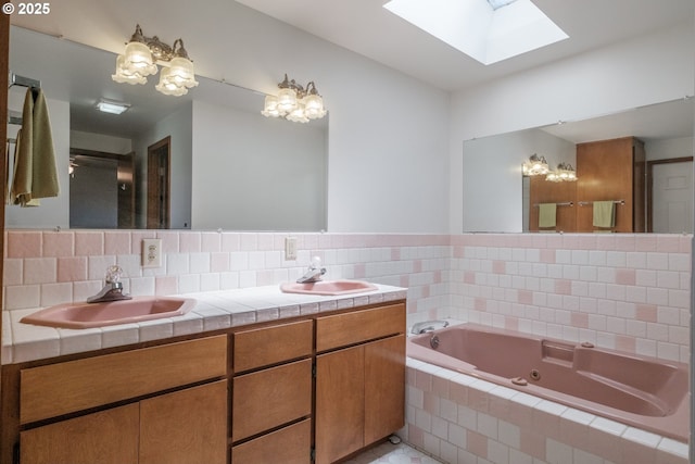 30563 Fairview Rd, Lebanon, OR 97355 - bathroom with a skylight, a tub with jets, double vanity, and tile patterned flooring