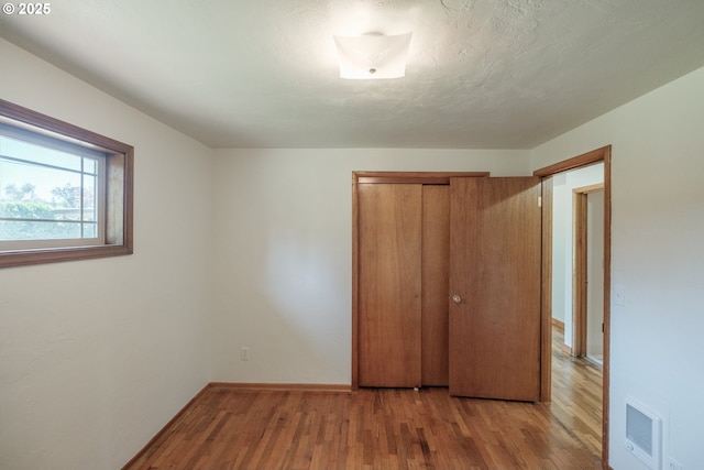 30563 Fairview Rd, Lebanon, OR 97355 - unfurnished bedroom with wood finished floors, a closet, and baseboards