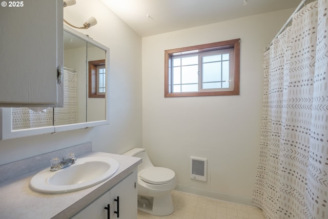 30563 Fairview Rd, Lebanon, OR 97355 - full bath with vanity, toilet, heating unit, baseboards, and tile patterned floors