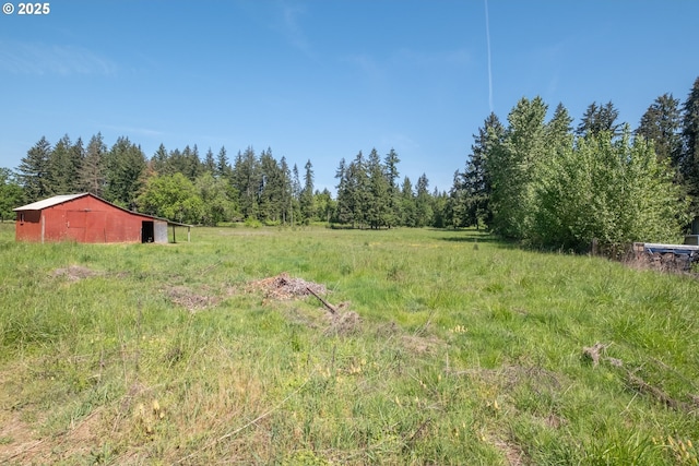 30563 Fairview Rd, Lebanon, OR 97355 - view of yard with an outdoor structure, a pole building, and a view of trees