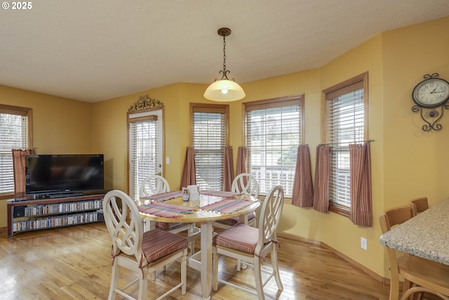 dining room featuring light wood-style floors and baseboards