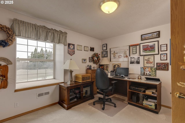 office featuring carpet, visible vents, and baseboards