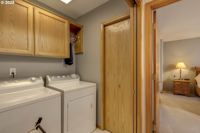 washroom featuring baseboards, separate washer and dryer, cabinet space, and light colored carpet