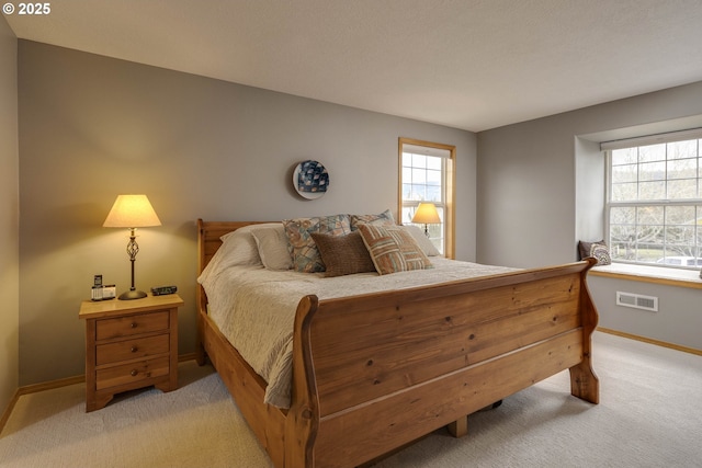 bedroom with light carpet, baseboards, and visible vents