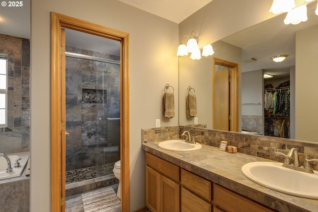 full bathroom with a stall shower, decorative backsplash, and a sink