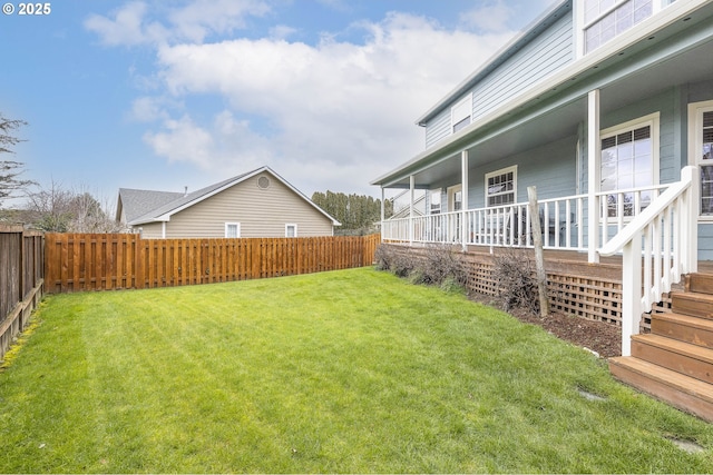 view of yard with covered porch and a fenced backyard