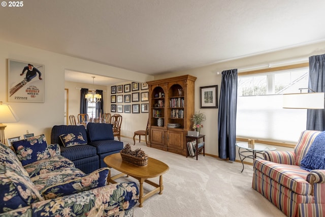 living area featuring a notable chandelier, baseboards, and light colored carpet