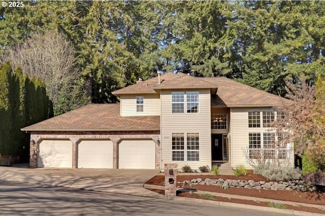 traditional-style home with concrete driveway and an attached garage