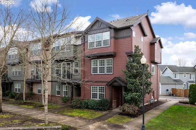 townhome / multi-family property featuring board and batten siding and brick siding