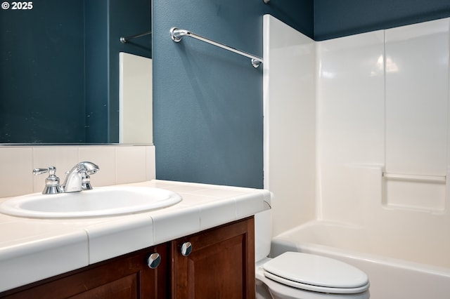 bathroom featuring toilet,  shower combination, decorative backsplash, and vanity