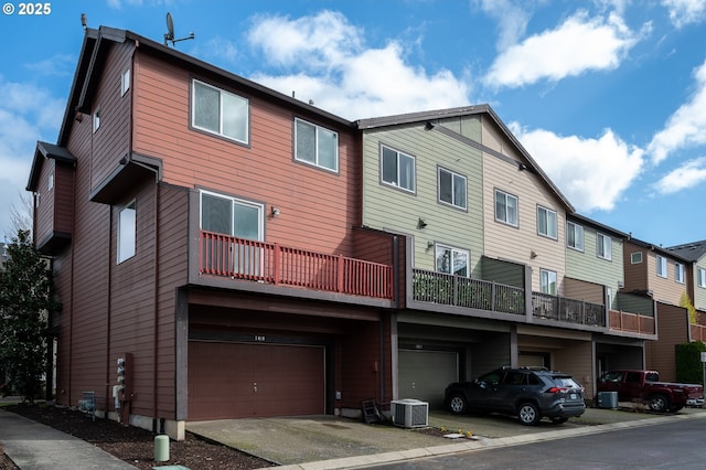 exterior space featuring an attached garage and central AC unit