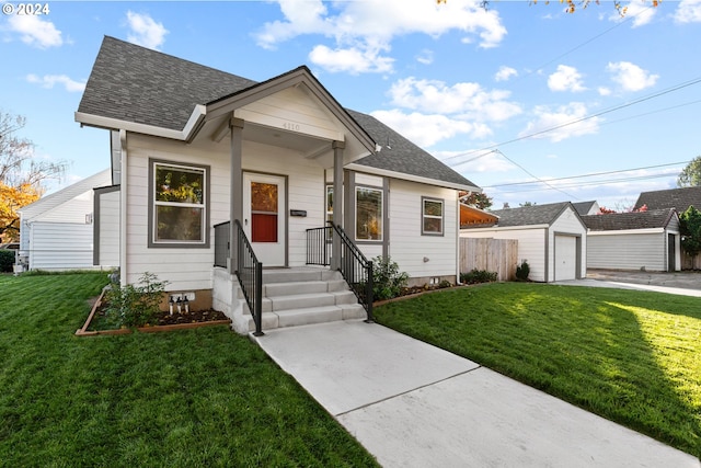 bungalow-style house featuring an outbuilding, fence, roof with shingles, a front lawn, and a garage