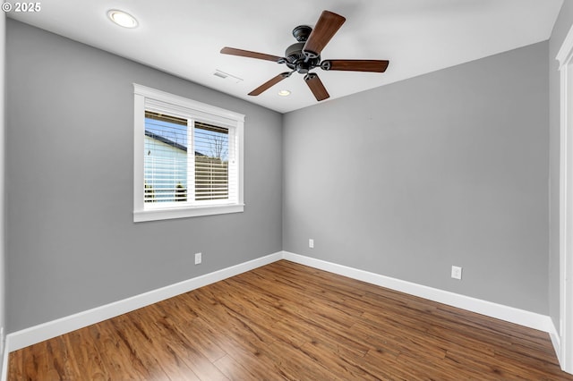 unfurnished room featuring recessed lighting, visible vents, ceiling fan, wood finished floors, and baseboards