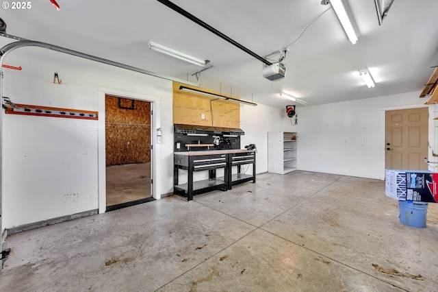 garage featuring a garage door opener and a workshop area