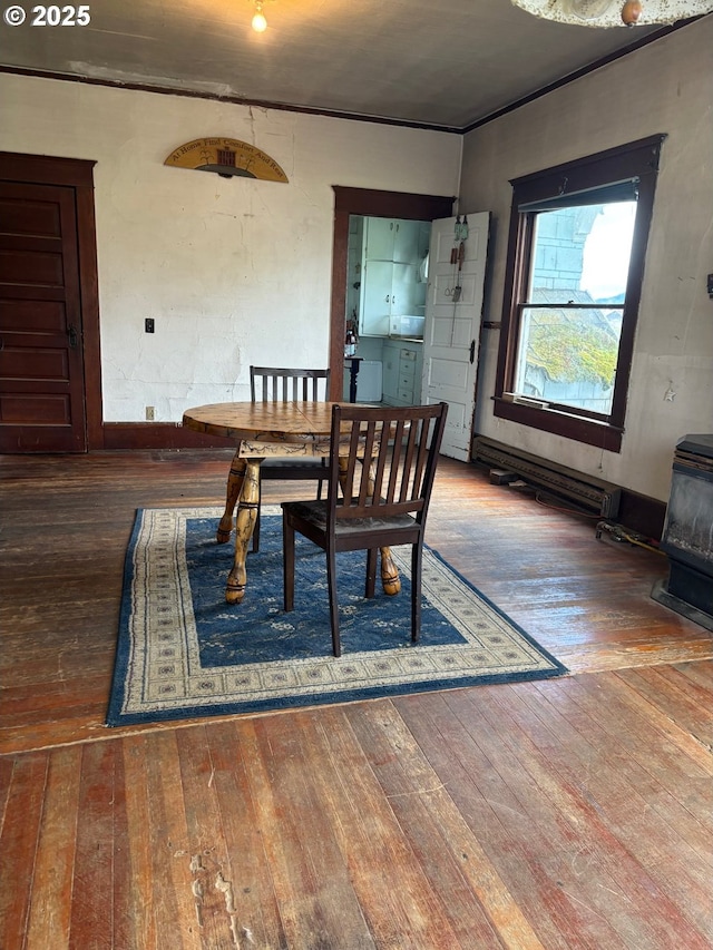 dining room with a wood stove and wood-type flooring