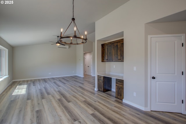 113 Citation Ct, Winston, OR 97496 - kitchen with a chandelier, vaulted ceiling, light wood-style floors, and baseboards